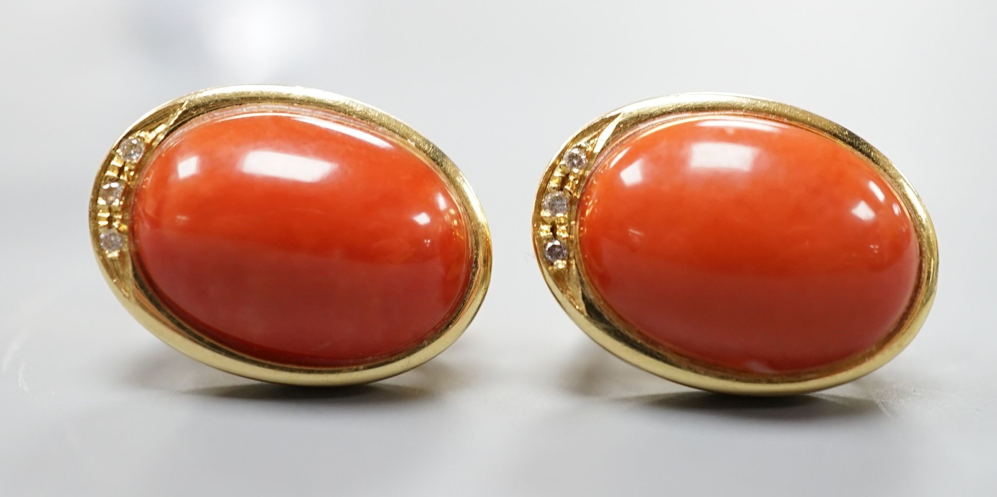 A pair of modern Italian 750 yellow metal a oval coral bead set earrings, 18mm, gross weight 11.7 grams.